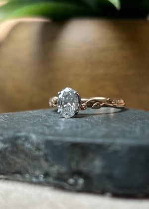 Gold ring with a large diamond on a dark surface
