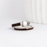 a wood wedding ring set made from white gold, walnut burl wood inlays, and a moissanite solitaire